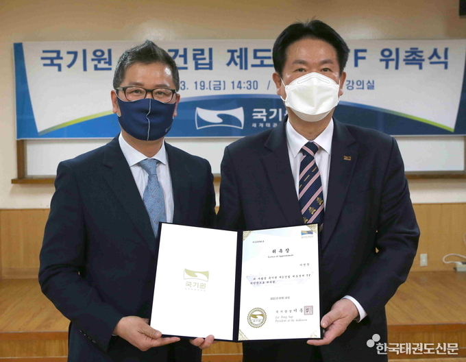 이동섭 국기원장(오른쪽)이 ‘국기원 제2건립 제도정비 TF’ 위원장으로 위촉한 이선장 계명대학교 교수에게 위촉장을 수여한 후 기념촬영을 하고 있다.