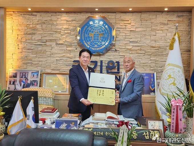 우)왕호 씨에게 명예 9단증을 수여하는 좌)이동섭 국기원장 